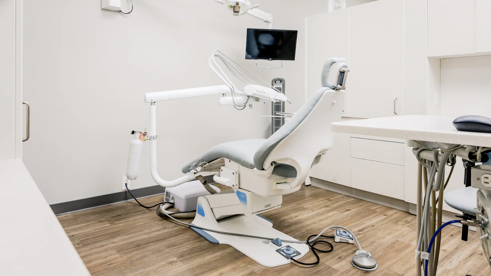 A bright, spotless treatment room with a modern dental chair