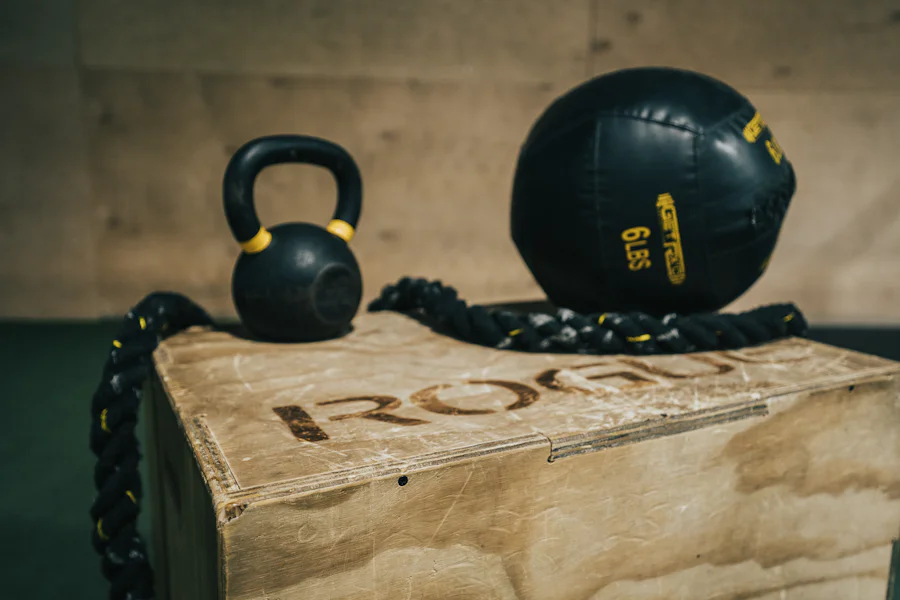 Kettlebells and a heavy bag in the corner of the studio