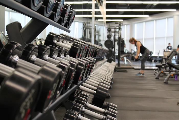 Rack of dumbbells running down a bright training floor
