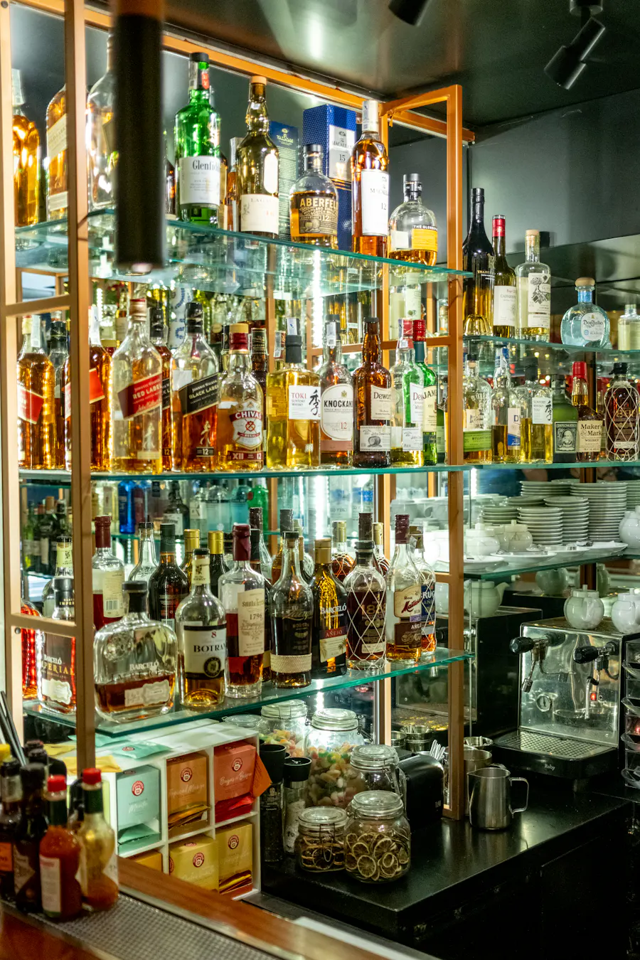 Bottles lined up on the shelves behind the bar