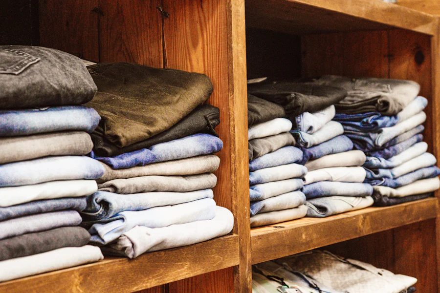 Folded lambswool knitwear stacked on wooden shelves