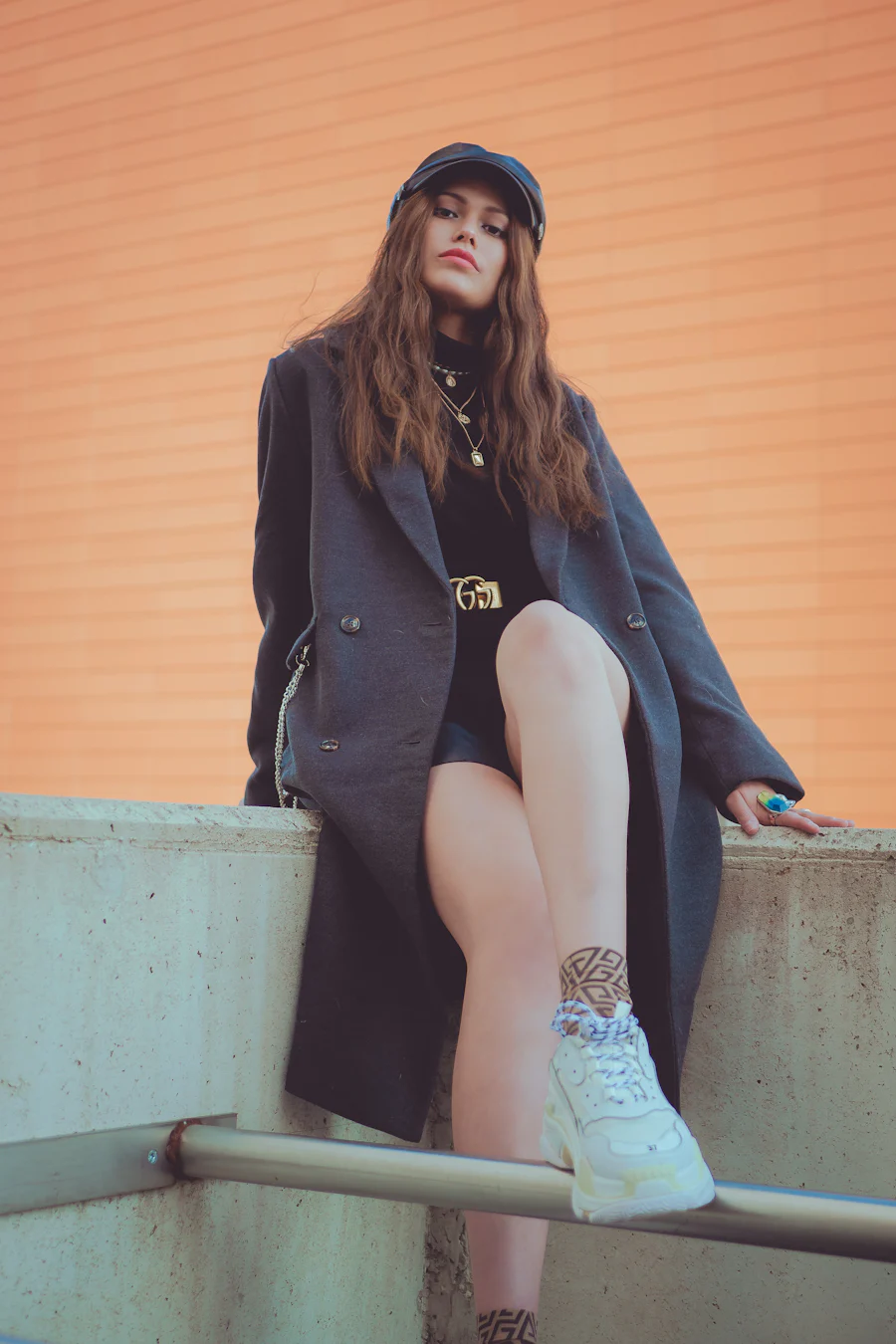 A styled outfit on a figure: high-waisted trousers and a soft overshirt