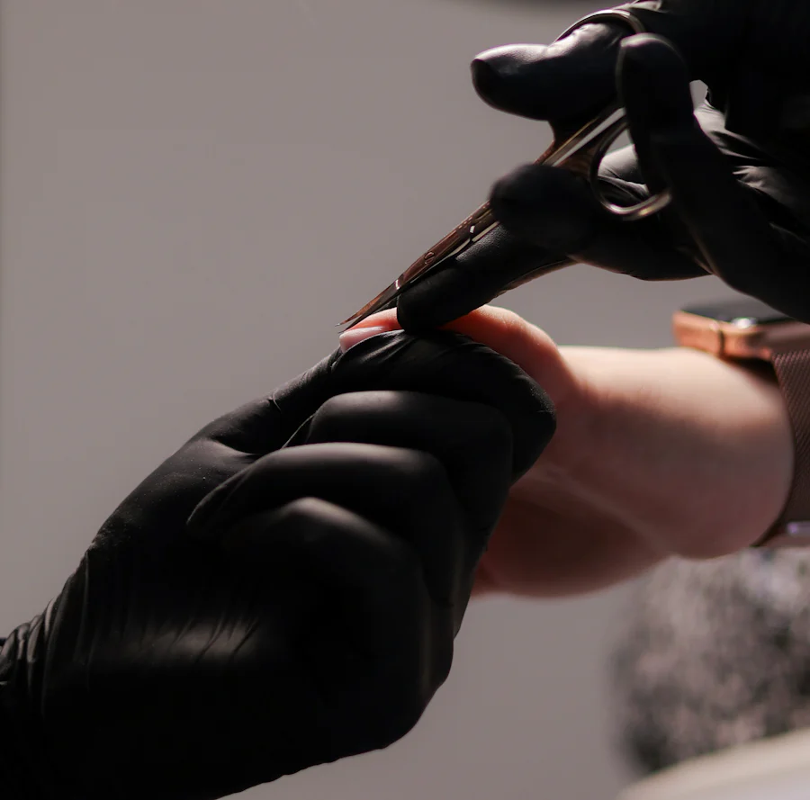 A stylist's hands finishing a client's hair