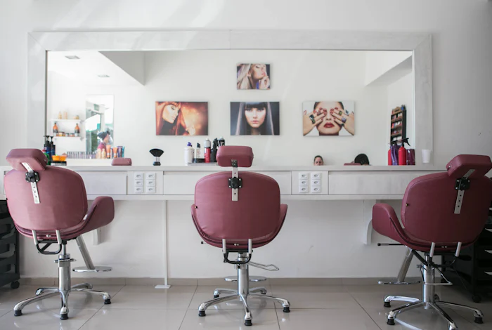 Salon interior with rose-coloured styling chairs